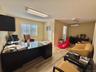 Office space featuring light wood-style flooring and an AC wall unit