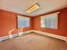 Empty room featuring baseboard heating and carpet flooring