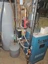 Utilities with water heater, electric panel, and a heating unit