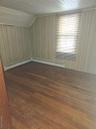 Bonus room featuring dark wood-style flooring and a baseboard radiator