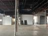 Misc room with healthy amount of natural light, electric water heater, and a garage