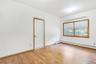 Empty room with a baseboard heating unit and light wood-style floors