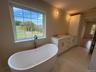 Photos of primary bathroom with similar look and finishing
