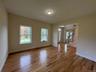Empty room featuring light wood finished floors and stairway