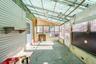 Unfurnished sunroom featuring vaulted ceiling and a patio area