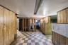Below grade area with light floors and wooden walls
