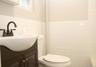 Bathroom featuring tile walls, vanity, and a wainscoted wall