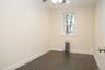 Spare room featuring radiator heating unit, dark wood-type flooring, and ceiling fan