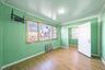Unfurnished bedroom featuring radiator heating unit, crown molding, multiple windows, and wood finished floors