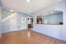 Unfurnished living room with light wood-style flooring, stairs, and arched walkways