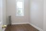 Spare room featuring radiator and dark wood-style floors