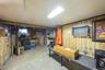 Finished basement featuring wood walls
