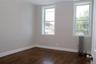 Unfurnished room with radiator heating unit and dark wood-type flooring