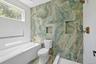 Bathroom featuring tile walls, a garden tub, and a tile shower