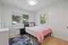 Bedroom featuring radiator and light wood-style floors