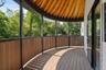Unfurnished sunroom with a deck and vaulted ceiling
