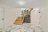 Foyer featuring stairway and light marble finish floors