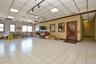 Office space featuring a drop ceiling, ornamental molding, light tile patterned flooring, and baseboards