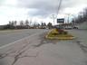 View of asphalt road with street lighting and curbs