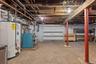 Unfinished basement featuring water heater and gas meter