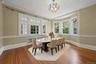Dining space with hardwood / wood-style flooring, plenty of natural light, crown molding, radiator heating unit, and a chandelier