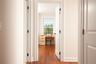 Hall with dark wood finished floors and baseboards