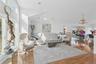 Living room featuring wood finished floors, recessed lighting, a chandelier, and high vaulted ceiling