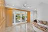 Living room with light marble finish flooring, recessed lighting, french doors, and a ceiling fan
