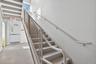 Staircase featuring concrete flooring