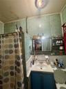 Bathroom with tile walls, tasteful backsplash, vanity, curtained shower, and ornamental molding
