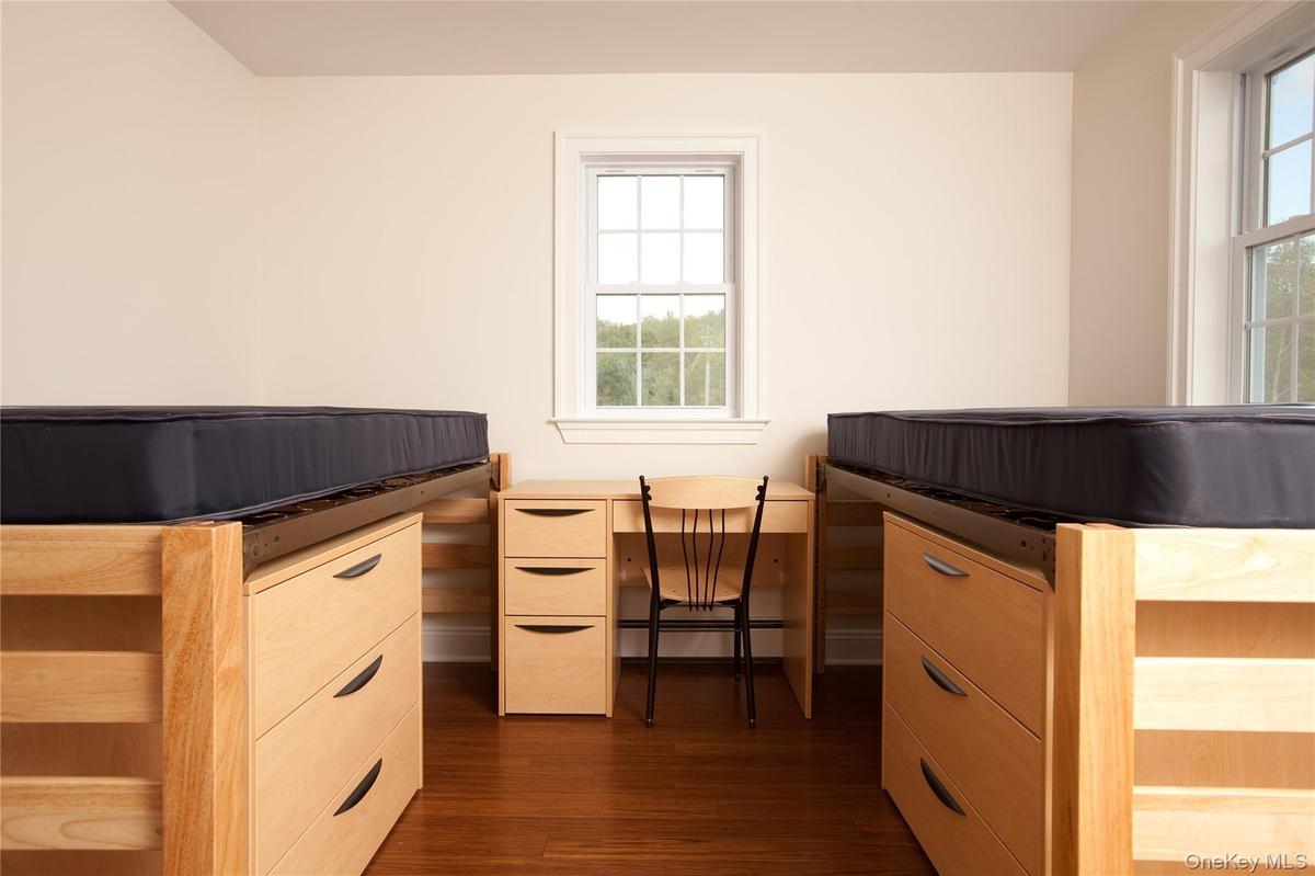 Bedroom featuring wood-style floors and baseboard heating