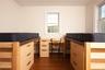 Bedroom featuring wood-style floors and baseboard heating
