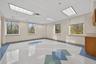 Unfurnished room with a drop ceiling and plenty of natural light