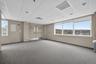 Carpeted spare room featuring healthy amount of natural light and a paneled ceiling