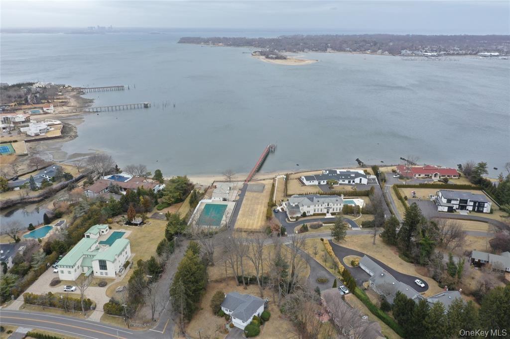 Aerial view of property's location featuring a nearby body of water and nearby suburban area