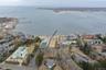 Aerial view of property's location featuring a nearby body of water and nearby suburban area