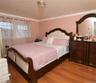 Bedroom with ornamental molding and wood finished floors