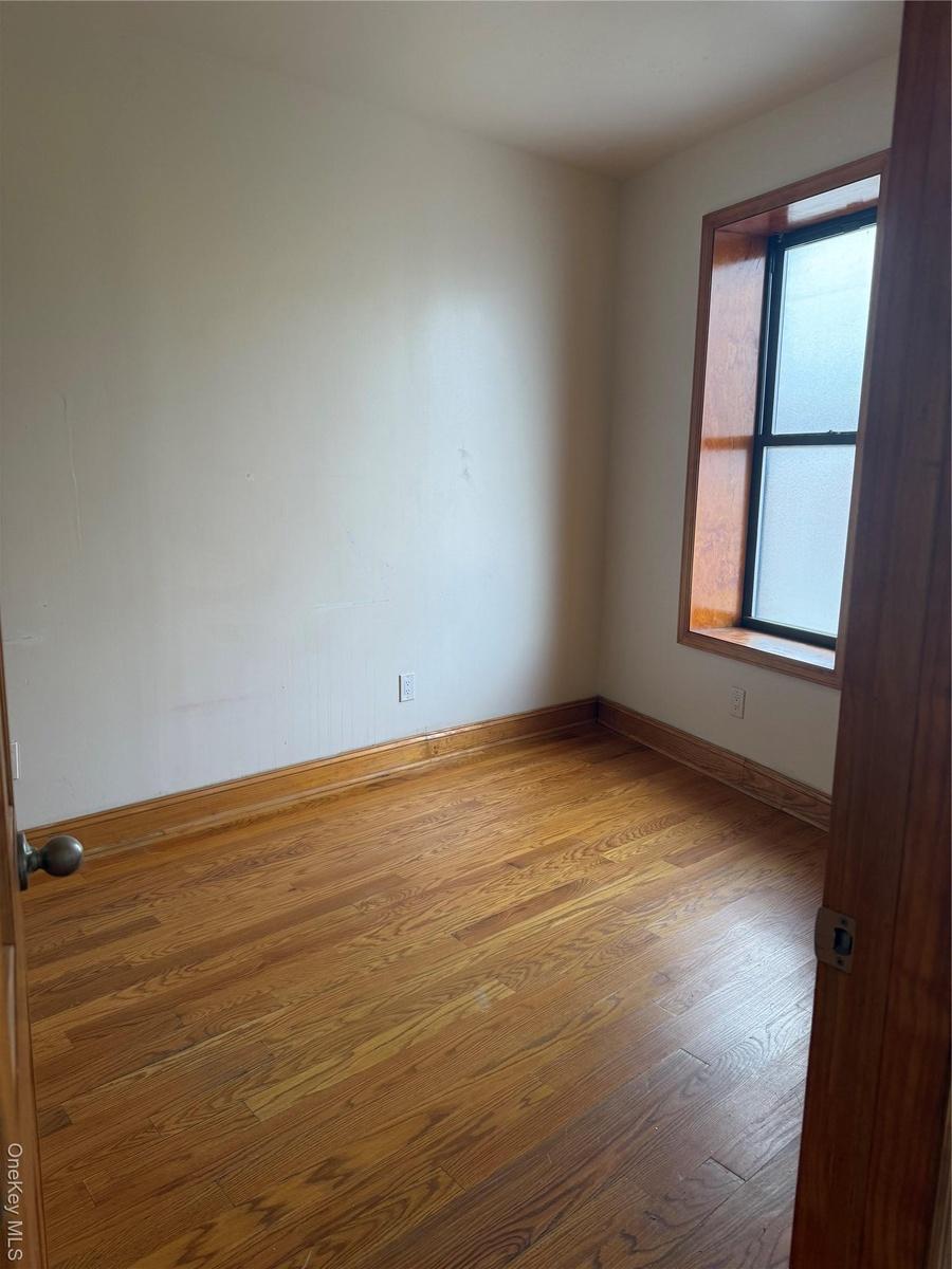 Spare room with wood finished floors and baseboards