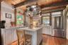 Kitchen with white cabinetry, open shelves, freestanding refrigerator, a wooden ceiling with exposed beams, and light wood finished floors