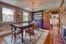 Dining area with wallpapered walls, light wood-type flooring, and a chandelier