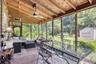 Sunroom with outdoor dining space, an outdoor hangout area, ceiling fan, and view of scattered trees