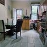 Kitchen featuring plenty of natural light, light tile patterned floors, fridge, and stove