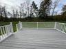 Wooden terrace featuring a yard