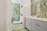 Full bathroom with vanity and a marble finish shower