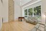 Living area featuring light wood-style flooring and high vaulted ceiling