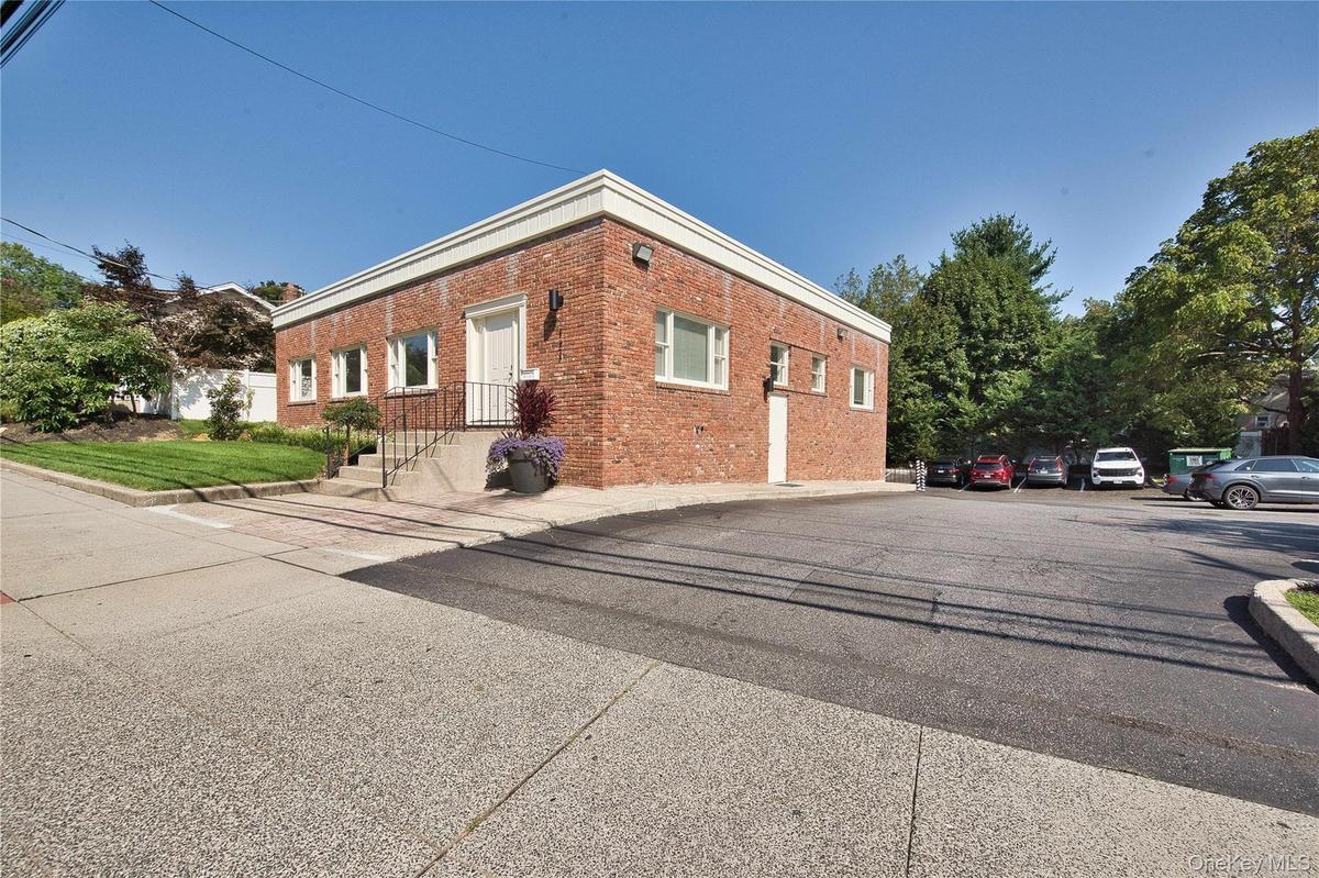 View of property exterior with brick siding