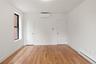 Unfurnished room with a baseboard heating unit, light wood finished floors, and a wall mounted air conditioner