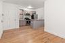 Kitchen with gray cabinets, light countertops, stainless steel appliances, and light wood finished floors