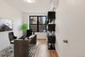 Home office featuring a wall unit AC and light wood-type flooring