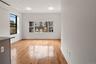Empty room featuring an AC wall unit and light wood-style flooring